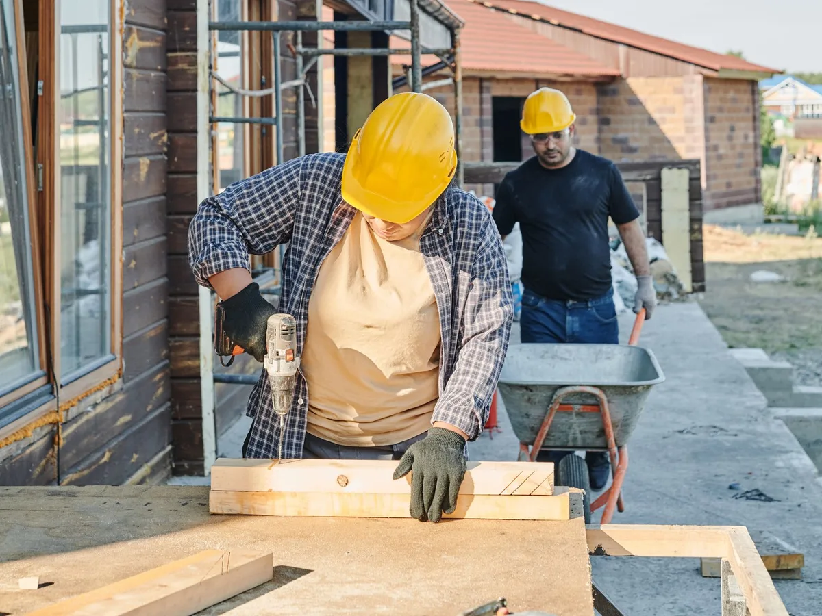 Two tradespeople working on a timber construction project