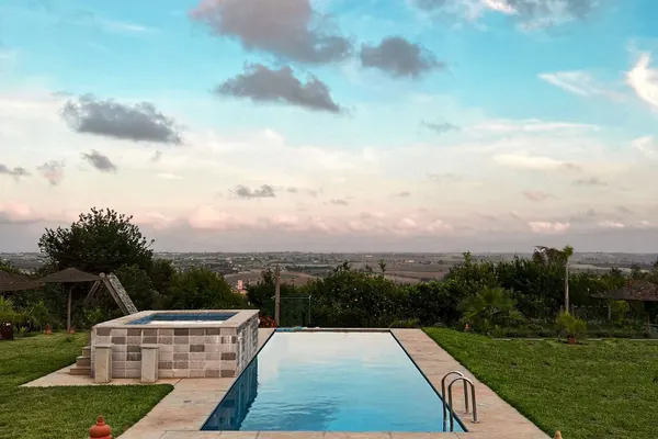 A swimming pool beside a landscaped garden