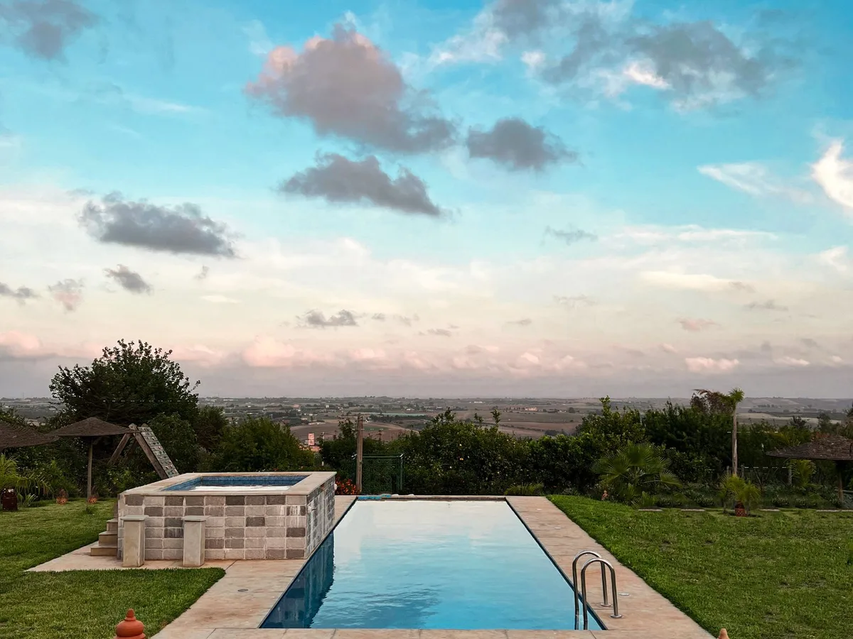 A swimming pool beside a landscaped garden